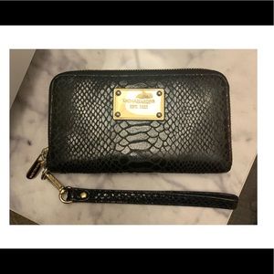 Michael Khor’s black snake skin wristlet